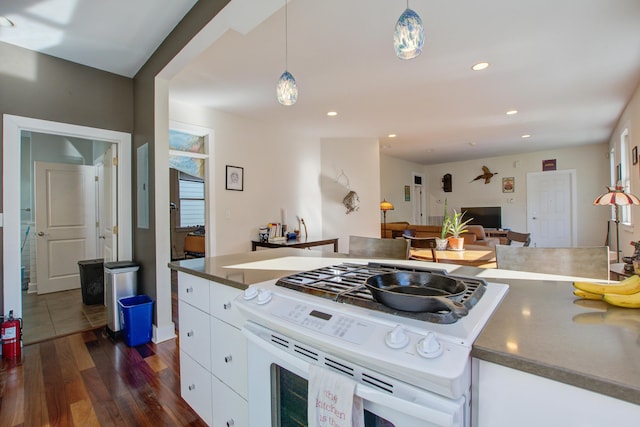 kitchen with decorative light fixtures, dark wood-style floors, recessed lighting, white cabinets, and white range with gas stovetop