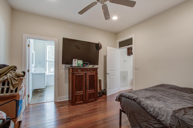 bedroom with a ceiling fan, wood finished floors, visible vents, and ensuite bathroom