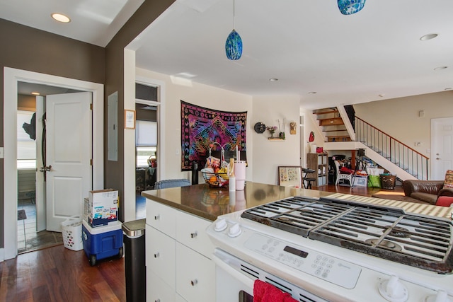 kitchen featuring blue cabinets, white gas stove, dark wood-style floors, open floor plan, and white cabinetry