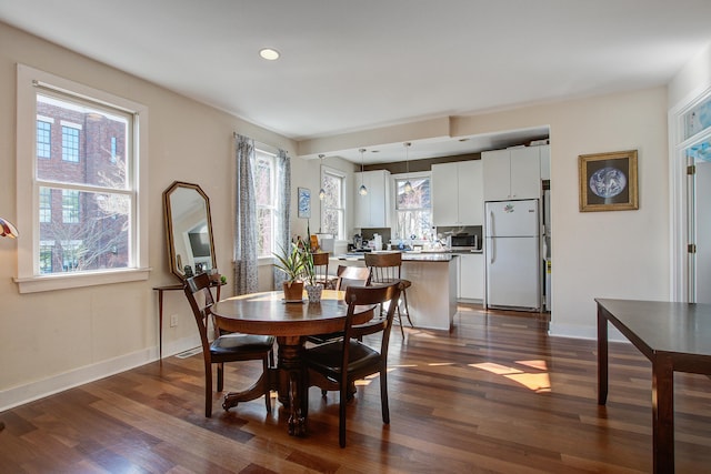 dining room featuring a toaster, recessed lighting, baseboards, and dark wood-style flooring