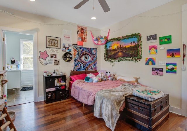 bedroom featuring baseboards, ceiling fan, recessed lighting, wood finished floors, and ensuite bath