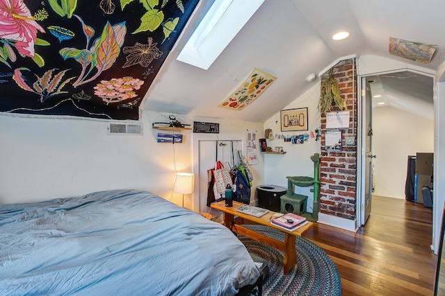 bedroom featuring lofted ceiling with skylight, visible vents, and hardwood / wood-style flooring