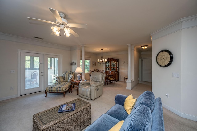 living room with ceiling fan with notable chandelier, ornate columns, ornamental molding, and light colored carpet