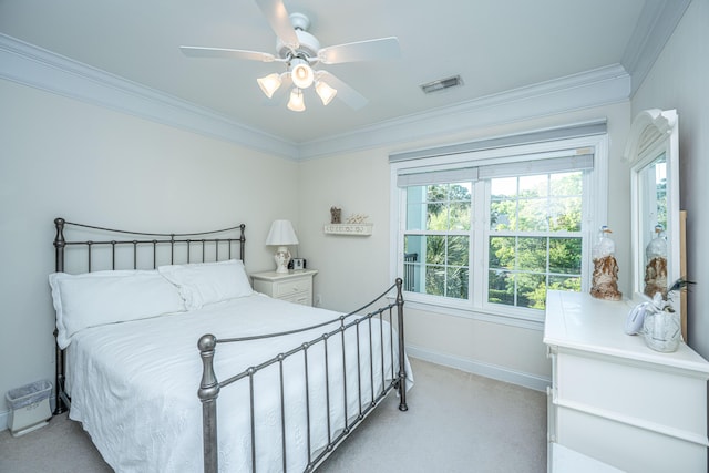 bedroom featuring light colored carpet, ornamental molding, multiple windows, and visible vents