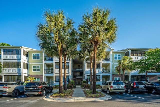 view of building exterior featuring uncovered parking