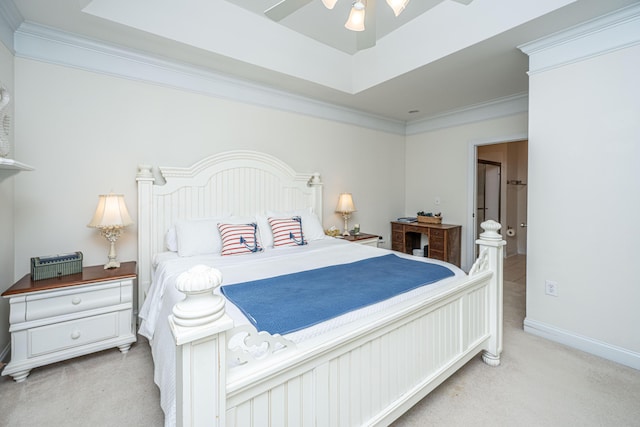 bedroom featuring a tray ceiling, carpet floors, and crown molding