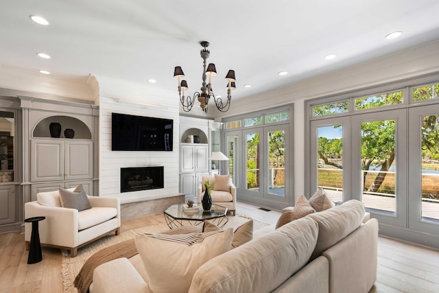 3508 Henrietta Hartford Rd, Mount Pleasant, SC 29466 - living room featuring crown molding, a chandelier, recessed lighting, light wood-style floors, and a premium fireplace