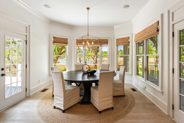3508 Henrietta Hartford Rd, Mount Pleasant, SC 29466 - dining room with a chandelier, light wood-style floors, baseboards, and crown molding
