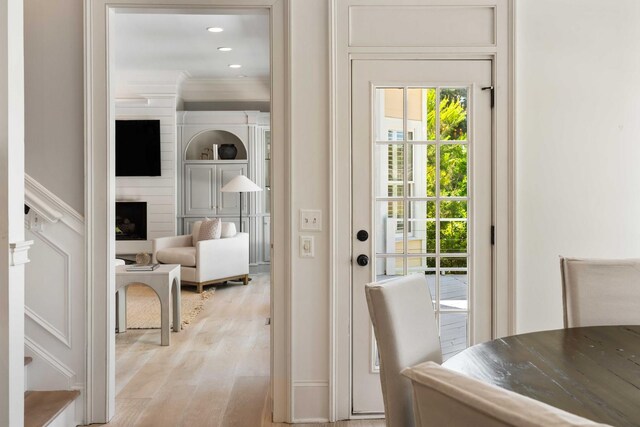 3508 Henrietta Hartford Rd, Mount Pleasant, SC 29466 - doorway to outside featuring light wood finished floors, crown molding, recessed lighting, and a large fireplace