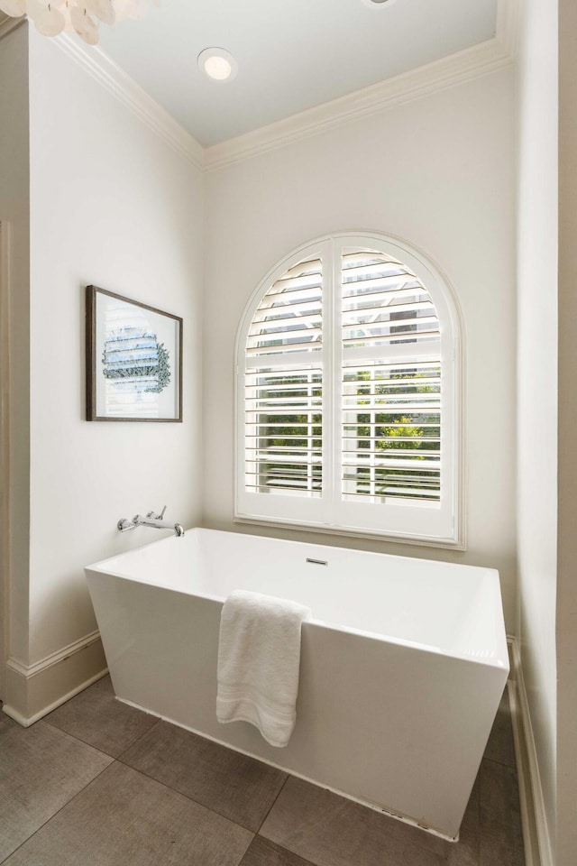 3508 Henrietta Hartford Rd, Mount Pleasant, SC 29466 - bathroom featuring a freestanding tub, crown molding, baseboards, and tile patterned flooring