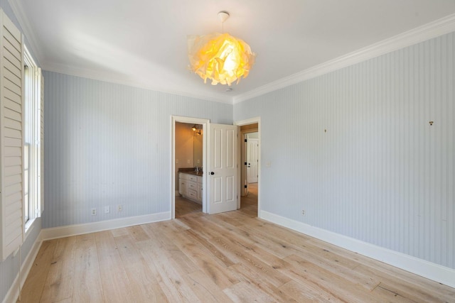 3508 Henrietta Hartford Rd, Mount Pleasant, SC 29466 - empty room featuring light wood-style flooring, crown molding, a chandelier, and baseboards