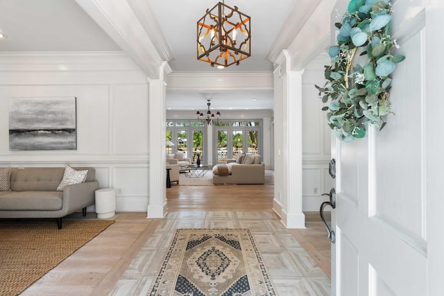 3508 Henrietta Hartford Rd, Mount Pleasant, SC 29466 - entrance foyer featuring a chandelier, decorative columns, a decorative wall, and ornamental molding