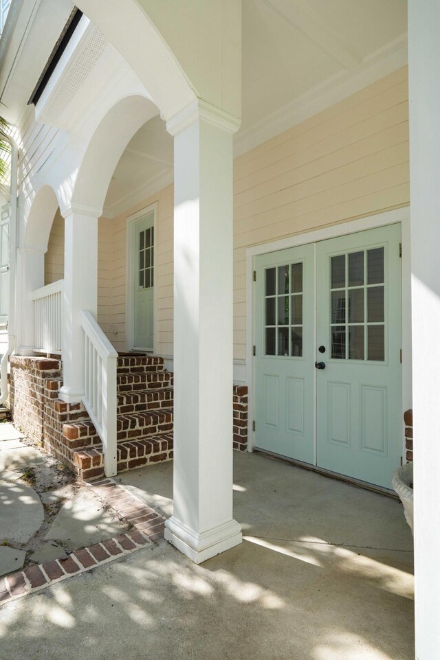 3508 Henrietta Hartford Rd, Mount Pleasant, SC 29466 - doorway to property with covered porch, brick siding, and french doors
