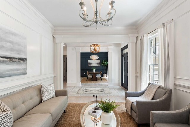 3508 Henrietta Hartford Rd, Mount Pleasant, SC 29466 - living room featuring a chandelier, a decorative wall, crown molding, plenty of natural light, and decorative columns