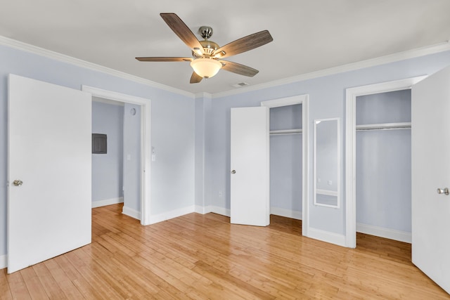 21 Rivers Point Row Unit 17G, Charleston, SC 29412 - unfurnished bedroom with two closets, crown molding, light wood-style flooring, baseboards, and a ceiling fan
