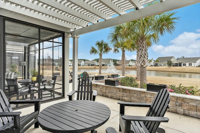 view of patio / terrace featuring a water view and a pergola