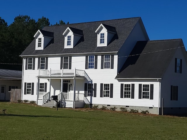 colonial-style house featuring a balcony and a front lawn