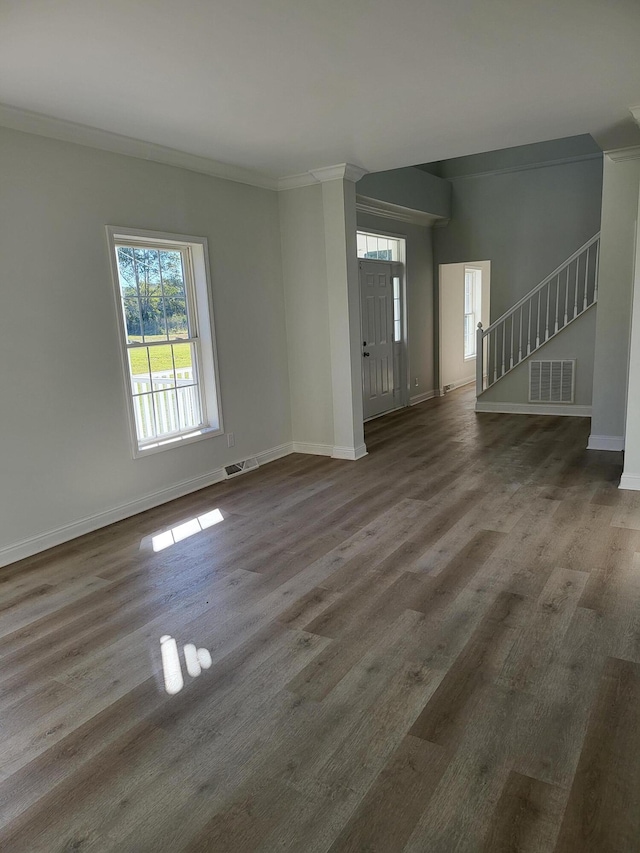 unfurnished room with crown molding and dark wood-type flooring