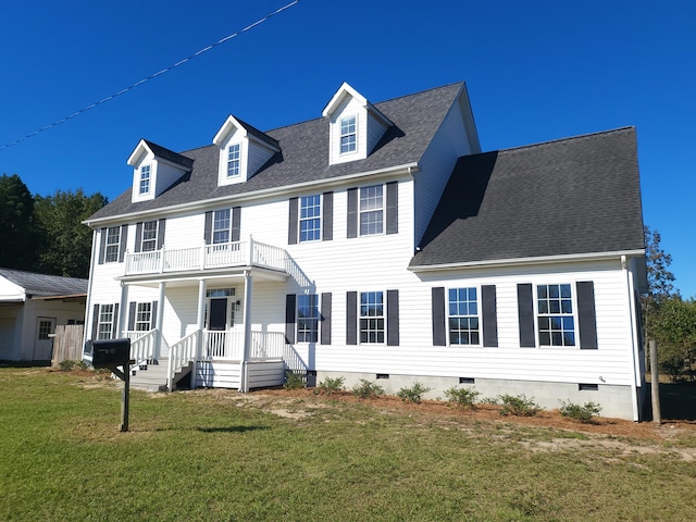 colonial-style house with a front lawn and a balcony