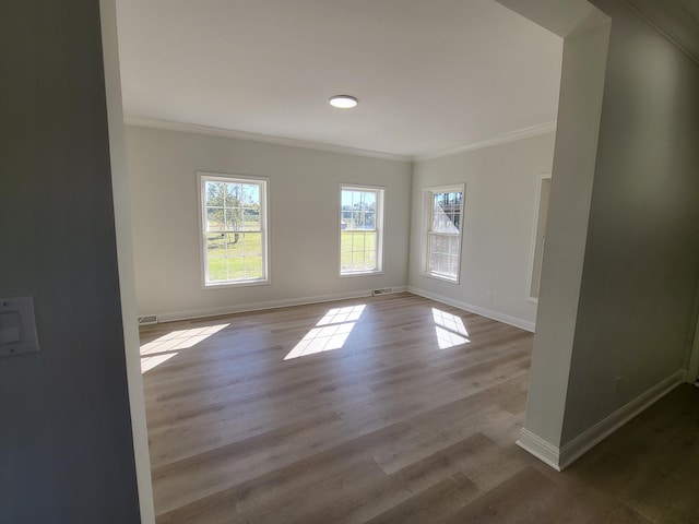 unfurnished room with ornamental molding and light hardwood / wood-style floors