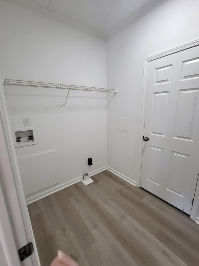 washroom featuring ornamental molding, hardwood / wood-style flooring, and washer hookup