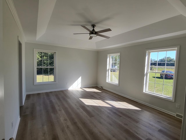 unfurnished room featuring dark wood-type flooring, crown molding, and a healthy amount of sunlight