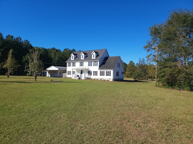 cape cod home with a front yard