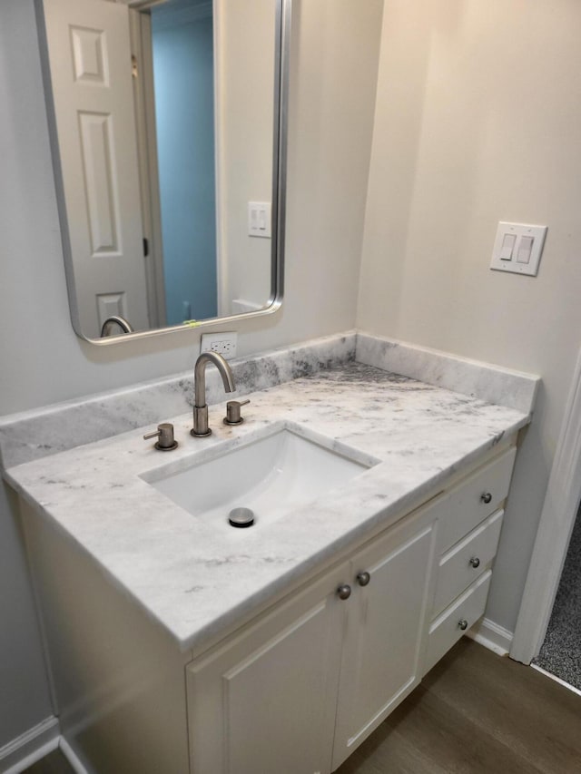 bathroom featuring vanity and hardwood / wood-style flooring