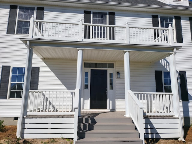 view of exterior entry with a porch