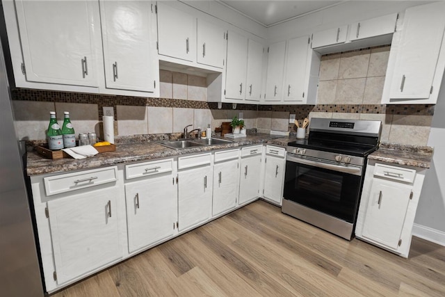 kitchen featuring white cabinetry, sink, and electric range