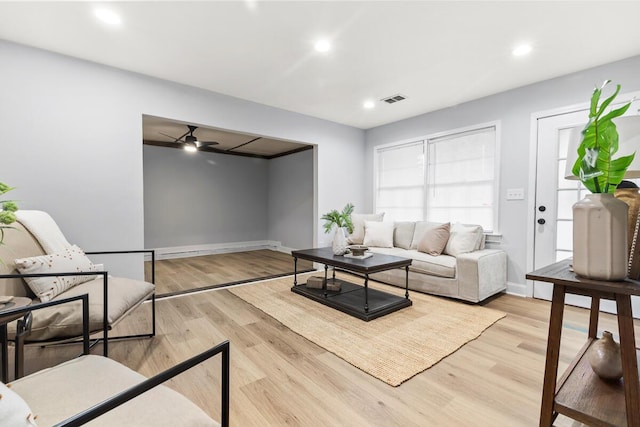 living room featuring ceiling fan and light wood-type flooring