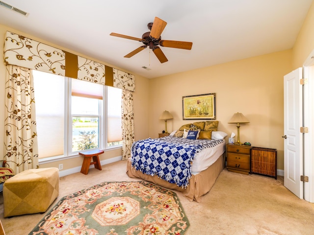 carpeted bedroom with baseboards, visible vents, and ceiling fan