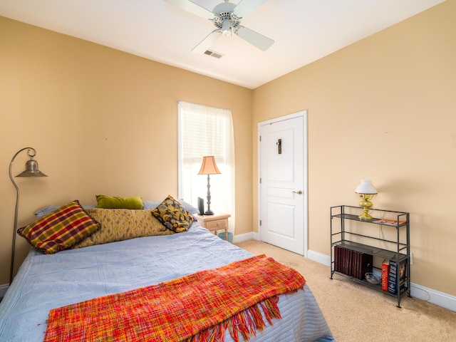 bedroom with light carpet, visible vents, ceiling fan, and baseboards