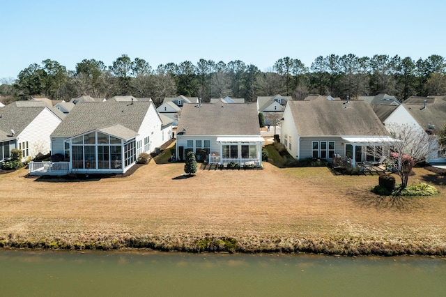 bird's eye view featuring a water view and a residential view