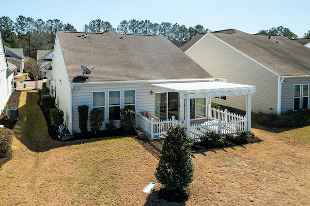 back of house featuring central AC unit, a lawn, a pergola, and roof with shingles