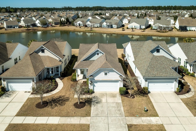 bird's eye view featuring a residential view and a water view