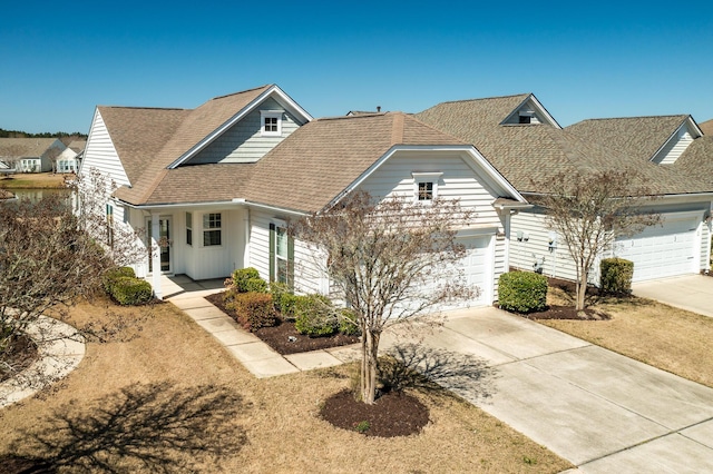 view of front of house with concrete driveway, an attached garage, and roof with shingles