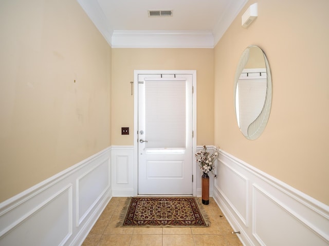 doorway to outside with light tile patterned flooring, visible vents, a decorative wall, and ornamental molding