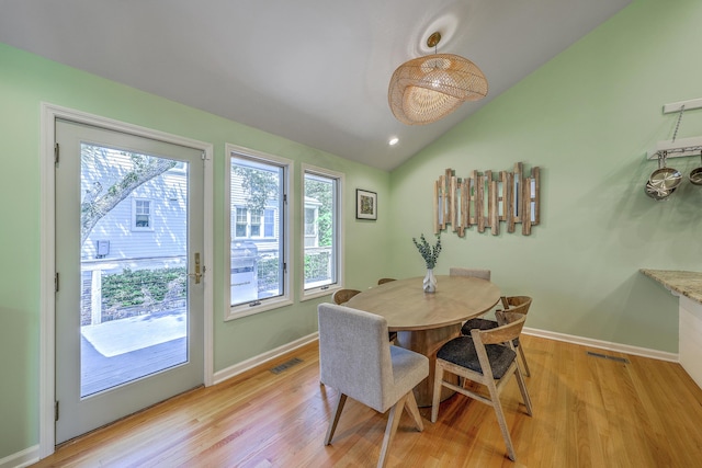 13 32nd Ave, Isle Of Palms, SC 29451 - dining area with plenty of natural light, lofted ceiling, light wood-style flooring, and baseboards