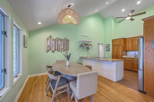 13 32nd Ave, Isle Of Palms, SC 29451 - dining area with light wood-style flooring, healthy amount of natural light, a ceiling fan, baseboards, and high vaulted ceiling