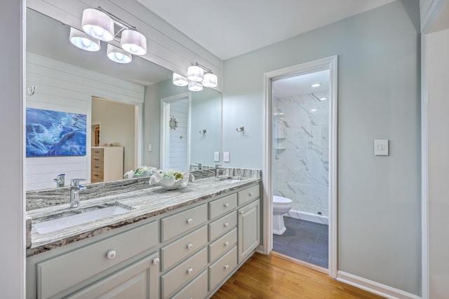 13 32nd Ave, Isle Of Palms, SC 29451 - full bath featuring wood finished floors, a marble finish shower, toilet, and double vanity
