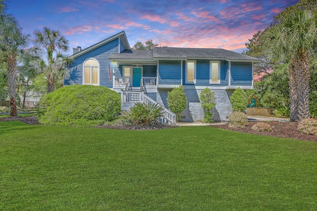 13 32nd Ave, Isle Of Palms, SC 29451 - view of front facade with stairway, covered porch, and a yard