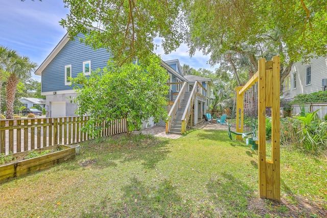 13 32nd Ave, Isle Of Palms, SC 29451 - view of yard with stairway, a garage, a deck, and a garden