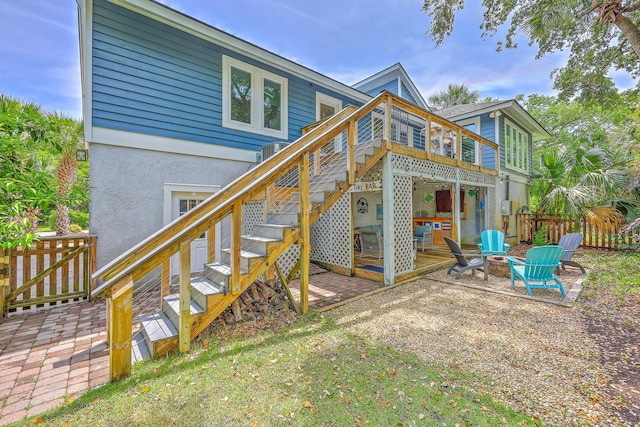 13 32nd Ave, Isle Of Palms, SC 29451 - back of house featuring a fire pit, fence, stucco siding, a patio, and stairs