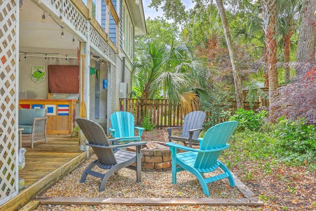 13 32nd Ave, Isle Of Palms, SC 29451 - view of patio featuring an outdoor fire pit, a wooden deck, and fence