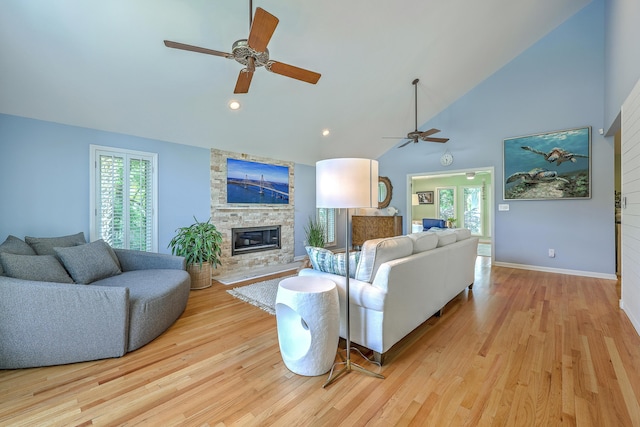 13 32nd Ave, Isle Of Palms, SC 29451 - living room featuring a ceiling fan, light wood-style flooring, high vaulted ceiling, a fireplace, and baseboards