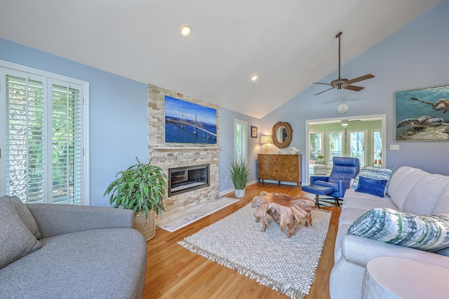 13 32nd Ave, Isle Of Palms, SC 29451 - living area with healthy amount of natural light, ceiling fan, a stone fireplace, wood finished floors, and high vaulted ceiling