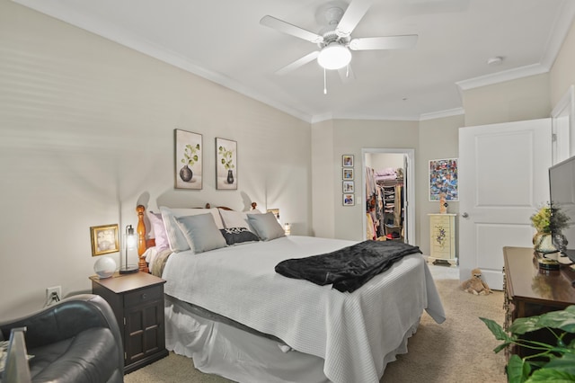 bedroom with crown molding, a spacious closet, a closet, and light colored carpet