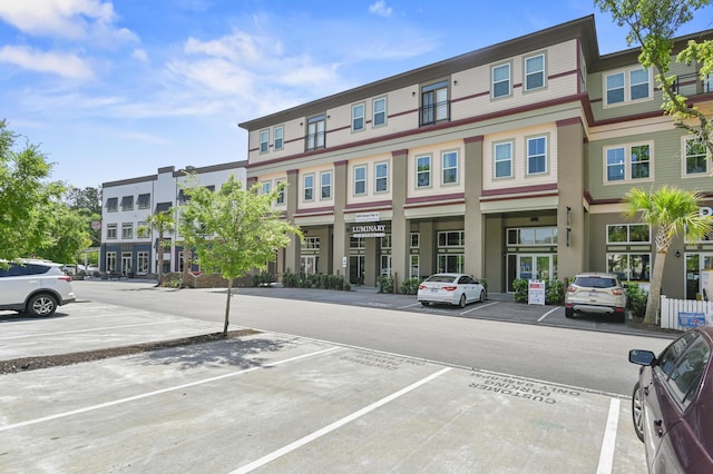 view of property featuring uncovered parking