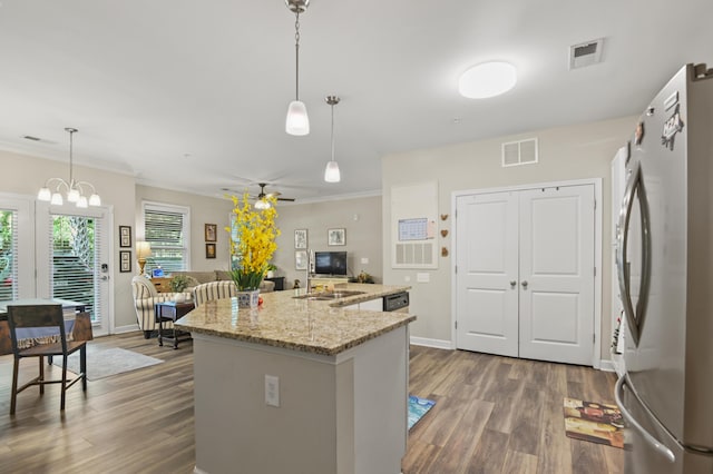 kitchen with freestanding refrigerator, visible vents, and dark wood-style floors